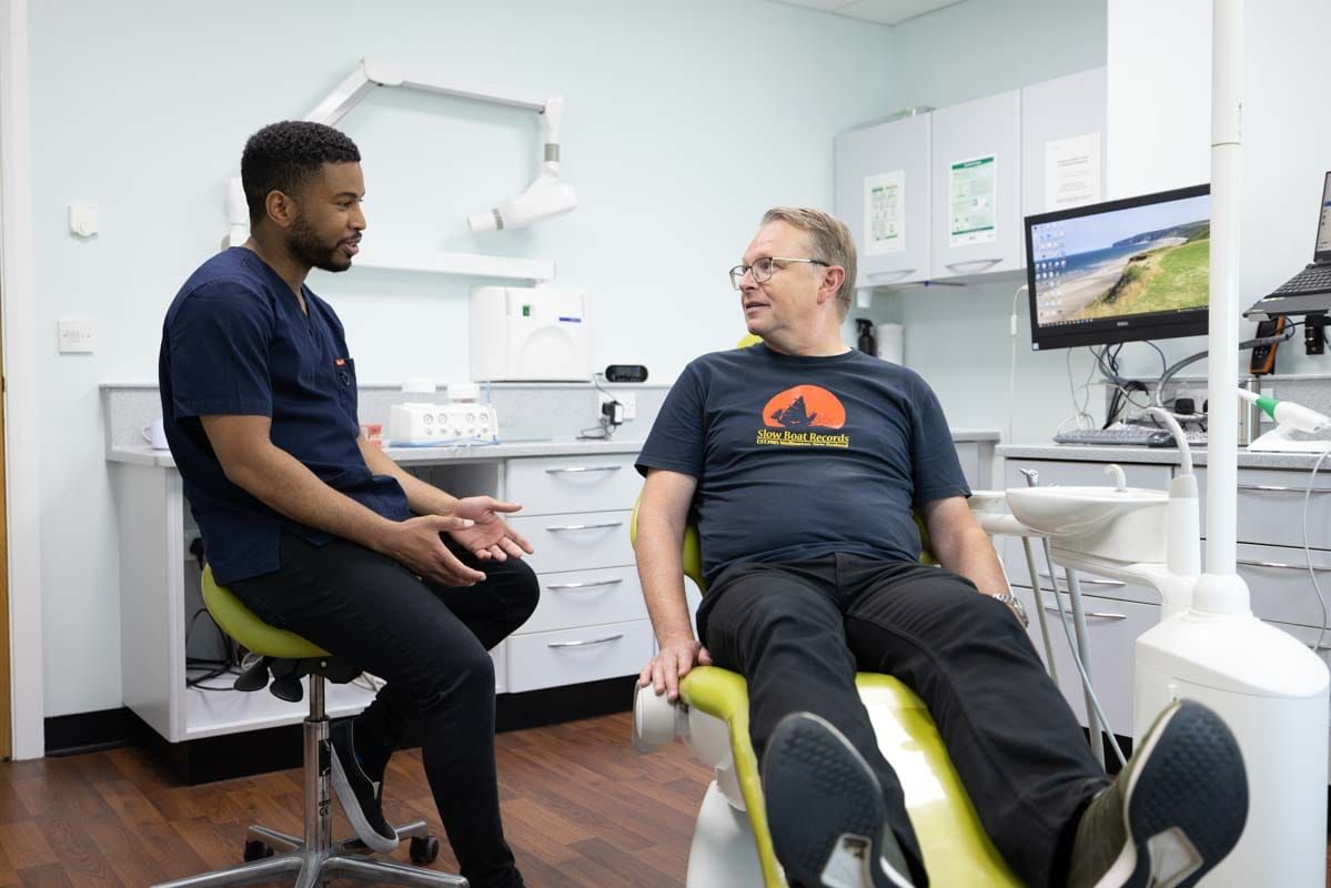 Andrew Stewart talking through Invisalign treatment with a patient at Castle Park Dental Care, Cottingham